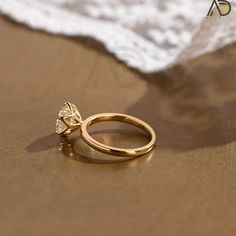 a close up of a gold ring on the beach