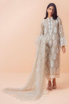 A stone-grey corduroy kurta with Aari embroidery is perfect for the summer festive season. It is paired with raw silk pants with lace detailing and an organza dupatta with scalloped edges. Elegant Cotton Silk Churidar With Intricate Embroidery, Elegant Semi-stitched Churidar For Spring, Elegant Spring Churidar With Dabka Work, Elegant Lace Work Organza Kurta, Elegant Lace Work Straight Kurta Lawn Suit, Festive Lace Work Organza Kurta, Elegant Organza Kurta With Lace Work, Designer Organza Kurta With Lace Work, Elegant Lawn Suit With Lace Work And Straight Kurta