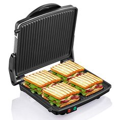 four sandwiches are being cooked in an electric griddle panini maker on a white surface