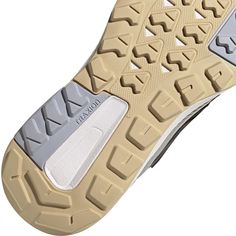 the sole of a pair of shoes with white and grey accents on top of it