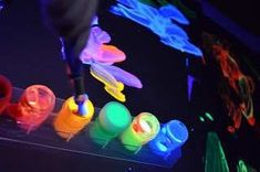 an assortment of plastic cups and spoons with lights on them