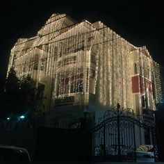 a house covered in christmas lights at night