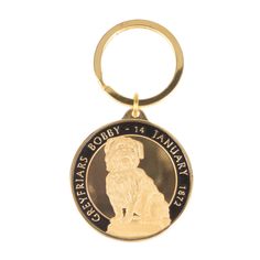 a keychain with a dog on it that says,'the bobby animal rescuers club '