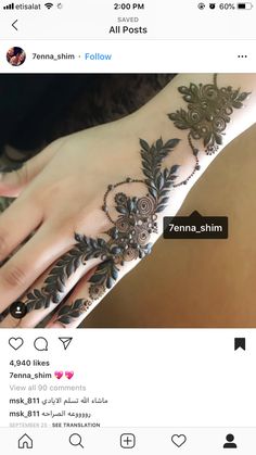 a woman's hand with henna tattoos on it and an instagramt