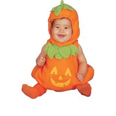 a baby dressed in an orange pumpkin costume