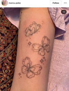 a woman's arm with three butterflies on it