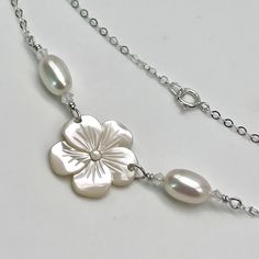 The luster of this mother of pearl plumeria shell is really beautiful, and I have accented it with two very lustrous and iridescent oval pearls that really pick up all the tones around them! Each oval freshwater pearl has a very delicate opal Swarovski crystal on each side. The flower is about 3/4 inch (19 mm) at the widest point and is accented with a Swarovski flat back crystal center. The pearls and flower section is about 2 inches ( 2 cm) and is wire wrapped to some delicate sterling silver chain that closes with a sterling silver spring clasp. This bracelet can be made in different lengths and can also be made as an anklet! This can also be made with gold filled chain and a gold filled clasp as well as a rose gold filled chain and clasp. There is a pair of earrings that goes with this Adjustable Mother Of Pearl Bracelet, Silver Spring, Dream Jewelry, Gold Filled Chain, Chain Link Bracelet, Link Bracelets, Sterling Silver Chains, Swarovski Crystal, Chain Link