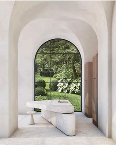 a white bench sitting under an arched window