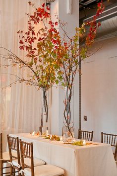 the table is set with flowers, candles and place settings for two people to sit at