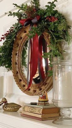 a christmas wreath is hanging on the mantle