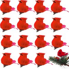 several red birds sitting on top of each other in front of a christmas tree branch