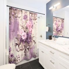 a bathroom with purple and white shower curtains