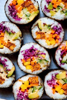 several sushi rolls with different toppings on them