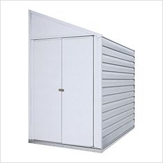 a white storage shed with the door open