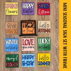 colorful magnets with words written on them sitting on a wooden table next to flowers