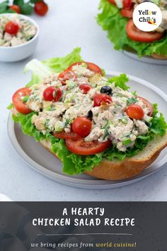 a chicken salad sandwich with lettuce and tomatoes