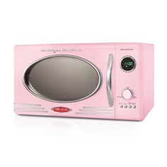 a pink microwave oven sitting on top of a white table