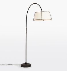 a floor lamp with a white shade on top and a black base, in the shape of a book