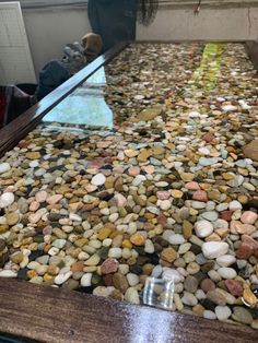 a glass table with rocks on it in a room