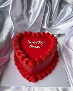 a heart shaped cake with the words twenty one written on it