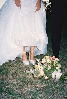 a bride and groom standing next to each other in front of a flowered bouquet