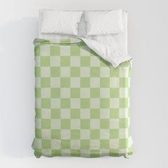 a green and white checkered comforter set with two pillow cases on top of it