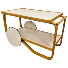 a wooden and glass table with wheels on it