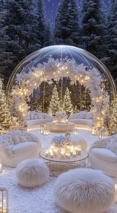 a living room filled with lots of white furniture and christmas lights on the trees in the background