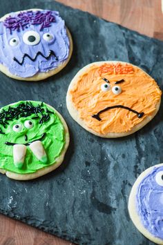 four decorated cookies with faces on them