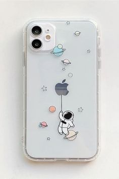 an iphone case with space and astronaut stickers on the back, sitting on top of a white surface