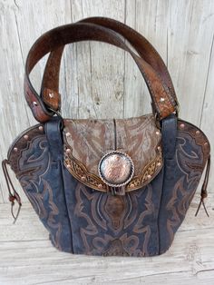 Double Cowboy Boot Purse Hand-Crafted from a Pair of Boots Tote Style (no pockets) No Two Alike Leather Body/Leather straps Western concho Leather Base Magnetic Closure Measures approx. 10"x12" FAQ's  Reviews Western Leather Purse, Best Cowboy Boots, Boot Purse, Cowboy Boot Purse, Statement Purse, Hipster Purse, Handmade Leather Purse, Western Handbags, Cowgirl Chic