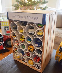 a toy truck is parked in front of a parking garage sign with cars and trucks on it