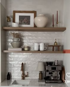 the shelves above the kitchen sink are filled with coffee cups and other things to drink