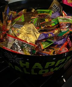 a black bowl filled with assorted candy bars