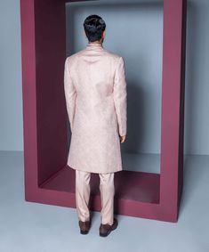 Elevate your style with a geometric pattern resham work achkan featuring intricate collar detailing. Paired effortlessly with a kurta and pants, this ensemble combines modern sophistication with meticulous craftsmanship, creating a refined and stylish look for various occasions. Luxury Pink Sherwani Straight Kurta, Pink Sherwani, Kurta And Pants, Resham Work, Nude Pink, Nirvana, Geometric Pattern, Collar, Pants