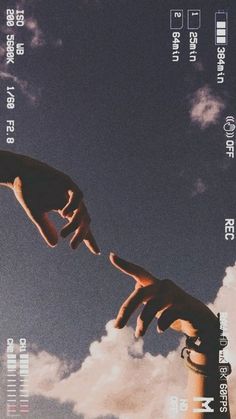 two hands reaching for each other in the sky