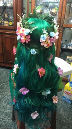 a green wig with flowers and leaves on it