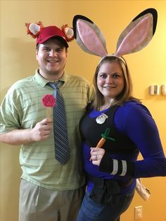 a man and woman are dressed up as bunny ears for an easter costume party with carrots on their heads