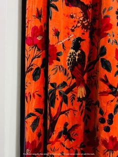 an orange curtain with birds and flowers on it