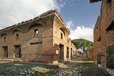 an old brick building with cobblestones on the ground