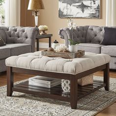 a living room with two couches, a coffee table and a rug on the floor