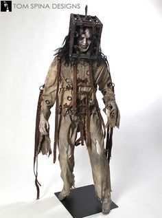 an image of a creepy scarecrow with chains and headpieces on white background