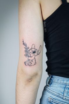 a woman with a small tattoo on her arm