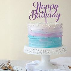 there is a cake that has been decorated with purple and blue frosting on it