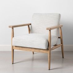 a chair sitting on top of a hard wood floor next to a white painted wall