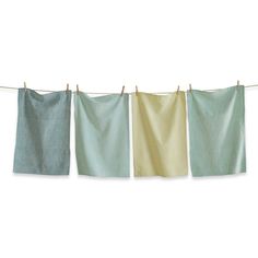 three teal and yellow towels hanging on a clothes line