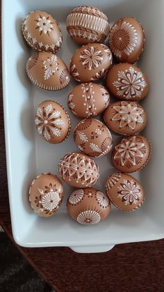 some brown and white decorated eggs in a bowl