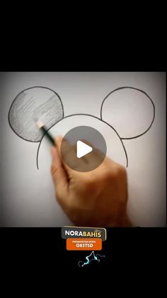 someone is drawing mickey mouse ears on the wall