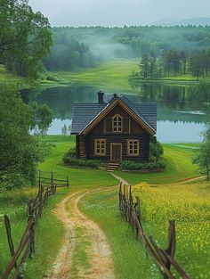 a small log cabin sits in the middle of a grassy field with a dirt path leading to it