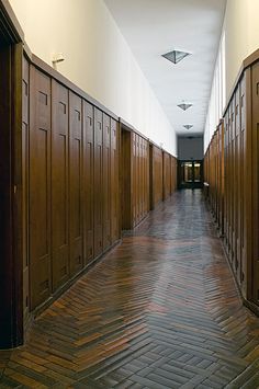 a long hallway lined with wooden lockers